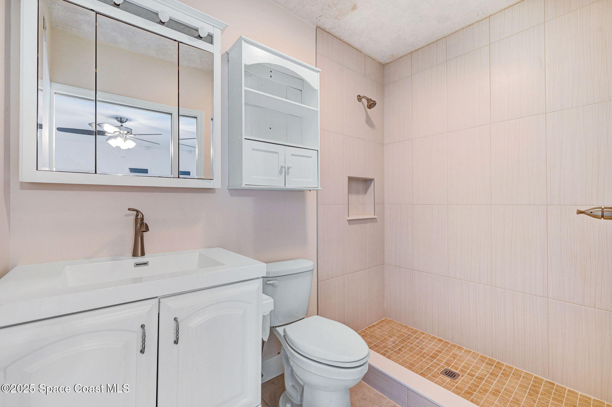 6094 Cardiff Avenue Cocoa, FL 32927 - Photo 37 of 48 a bathroom with a sink a toilet and shower