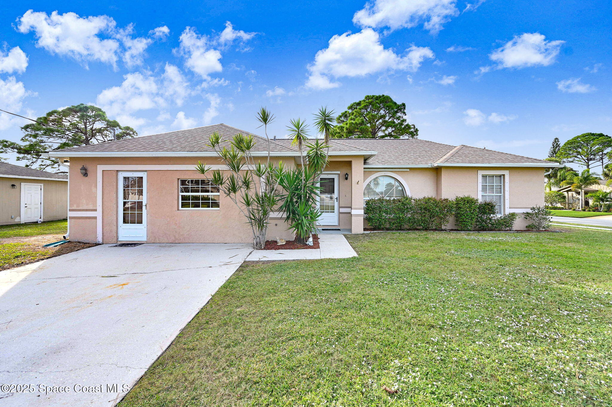 6094 Cardiff Avenue Cocoa, FL 32927 - Photo 47 of 48 a front view of a house with a garden and yard