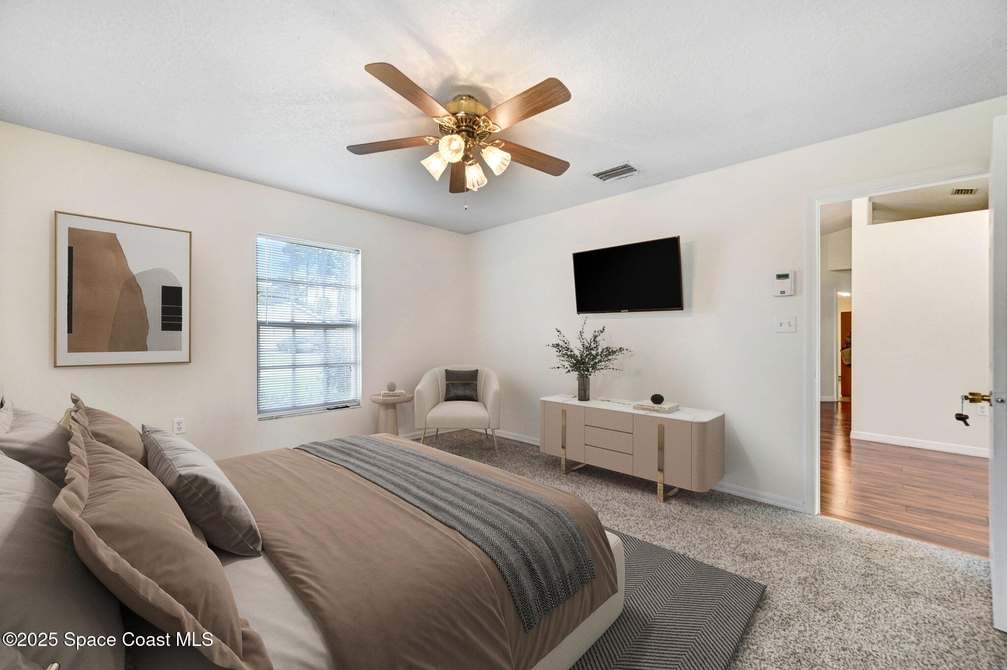 6094 Cardiff Avenue Cocoa, FL 32927 - Photo 5 of 48 a bedroom with a bed and a flat screen tv