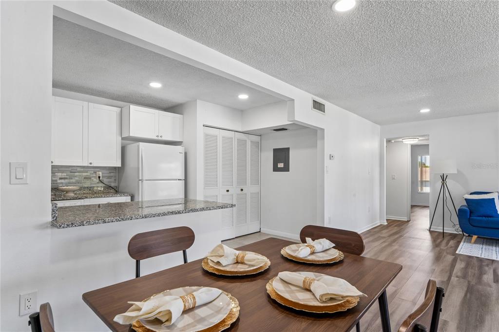 2522 Pine Ridge Way South, Unit D2 Palm Harbor, FL 34684 - Photo 12 of 38 a kitchen with a table and chairs