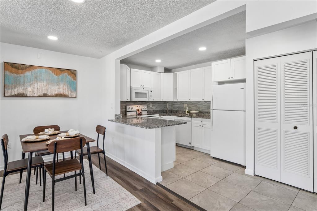 2522 Pine Ridge Way South, Unit D2 Palm Harbor, FL 34684 - Photo 13 of 38 a kitchen with a refrigerator and white cabinets