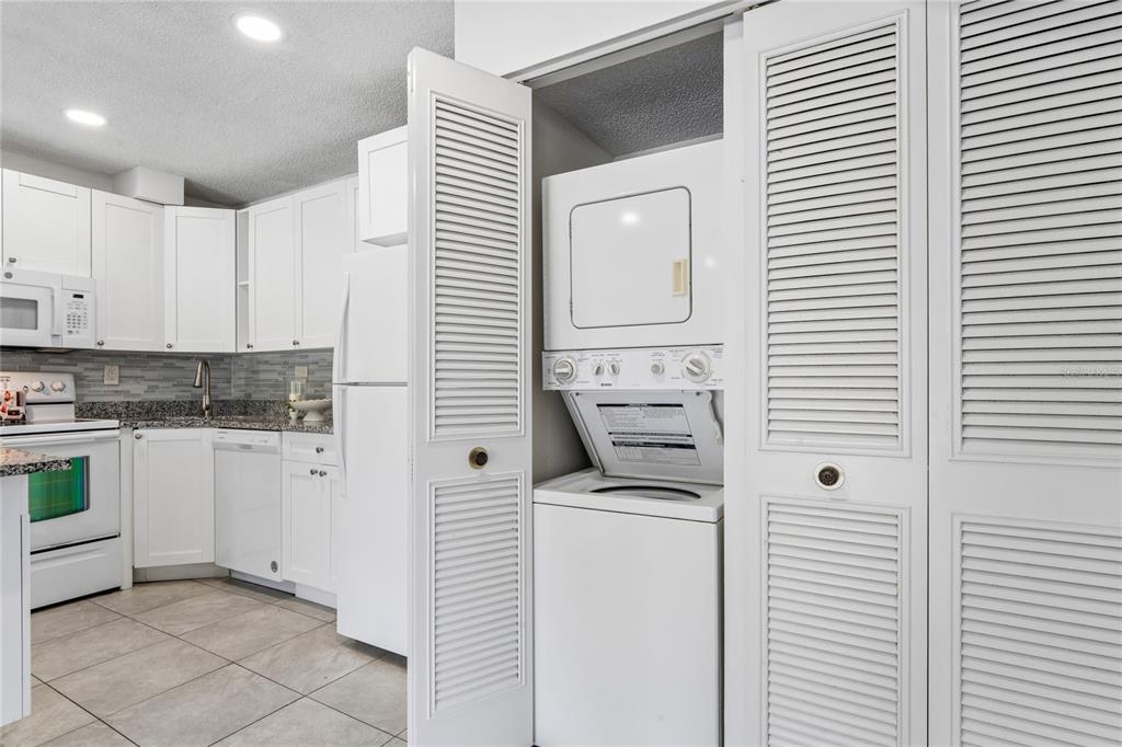 2522 Pine Ridge Way South, Unit D2 Palm Harbor, FL 34684 - Photo 16 of 38 a kitchen with white cabinets and white appliances