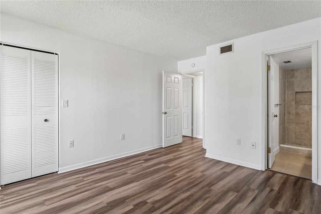 2522 Pine Ridge Way South, Unit D2 Palm Harbor, FL 34684 - Photo 18 of 38 a view of an empty room with wooden floor