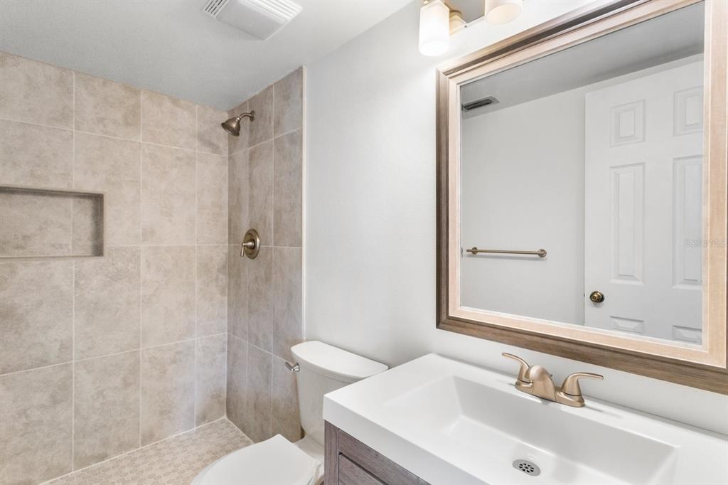 2522 Pine Ridge Way South, Unit D2 Palm Harbor, FL 34684 - Photo 19 of 38 a bathroom with a sink and a mirror