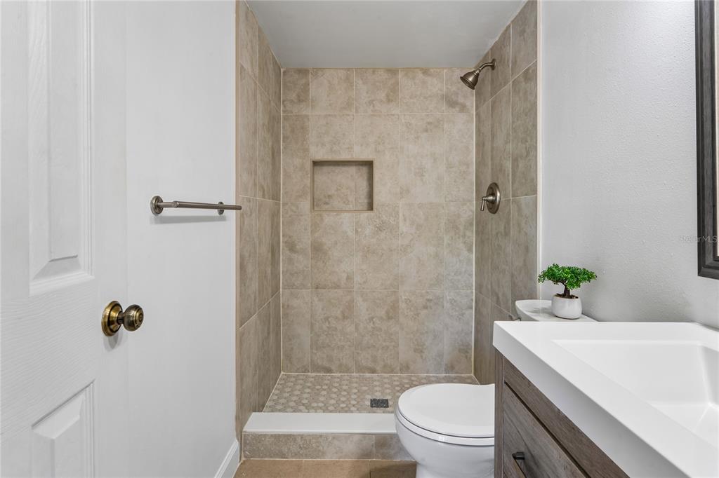 2522 Pine Ridge Way South, Unit D2 Palm Harbor, FL 34684 - Photo 20 of 38 a bathroom with a sink toilet and shower