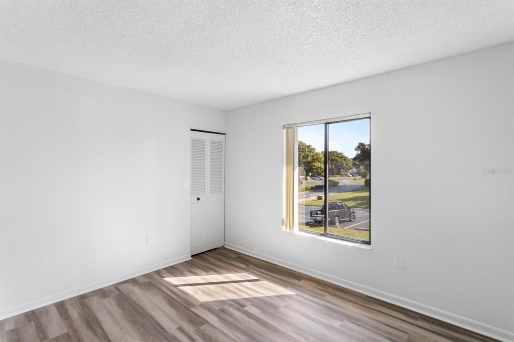 2522 Pine Ridge Way South, Unit D2 Palm Harbor, FL 34684 - Photo 22 of 38 an empty room with windows
