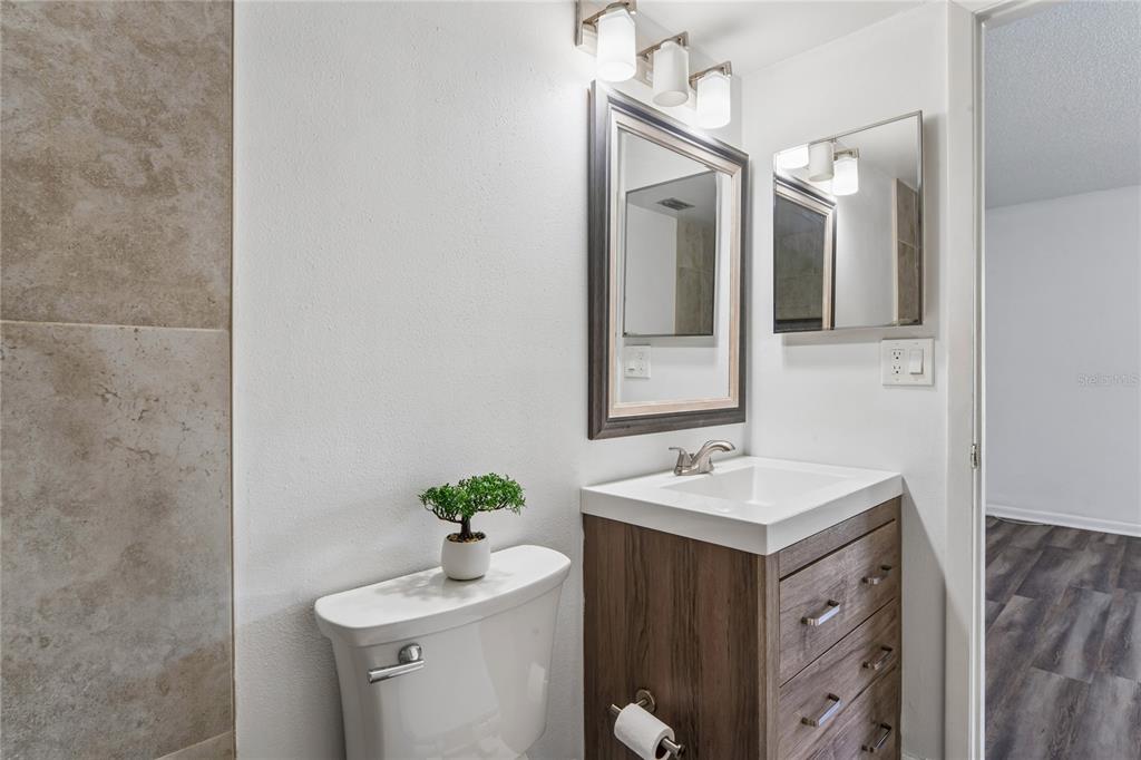 2522 Pine Ridge Way South, Unit D2 Palm Harbor, FL 34684 - Photo 25 of 38 a bathroom with a sink vanity and mirror