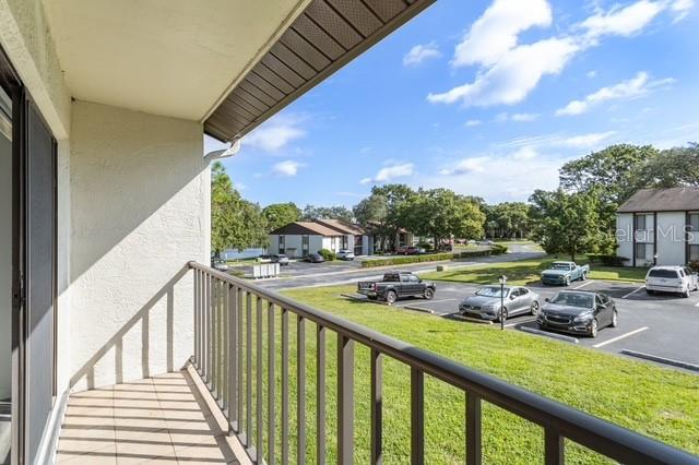 2522 Pine Ridge Way South, Unit D2 Palm Harbor, FL 34684 - Photo 29 of 38 a view of house with outdoor space and seating area