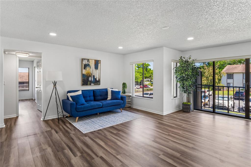2522 Pine Ridge Way South, Unit D2 Palm Harbor, FL 34684 - Photo 8 of 38 a living room with furniture and a wooden floor