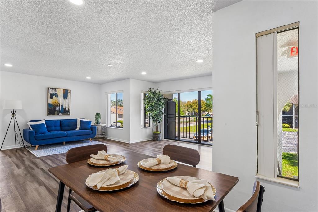 2522 Pine Ridge Way South, Unit D2 Palm Harbor, FL 34684 - Photo 9 of 38 a living room with furniture and a wooden floor