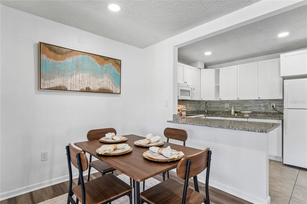 2522 Pine Ridge Way South, Unit D2 Palm Harbor, FL 34684 - Photo 10 of 38 a view of a kitchen area with furniture and wooden floor