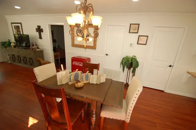 a view of a dining room with furniture and wooden floor