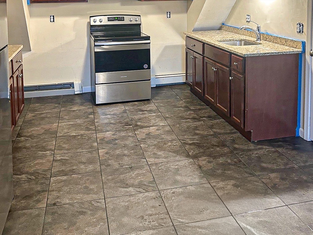 79 Kilmer Avenue Taunton, MA 02780 - Photo 10 of 13 a kitchen with a stove top oven and cabinets