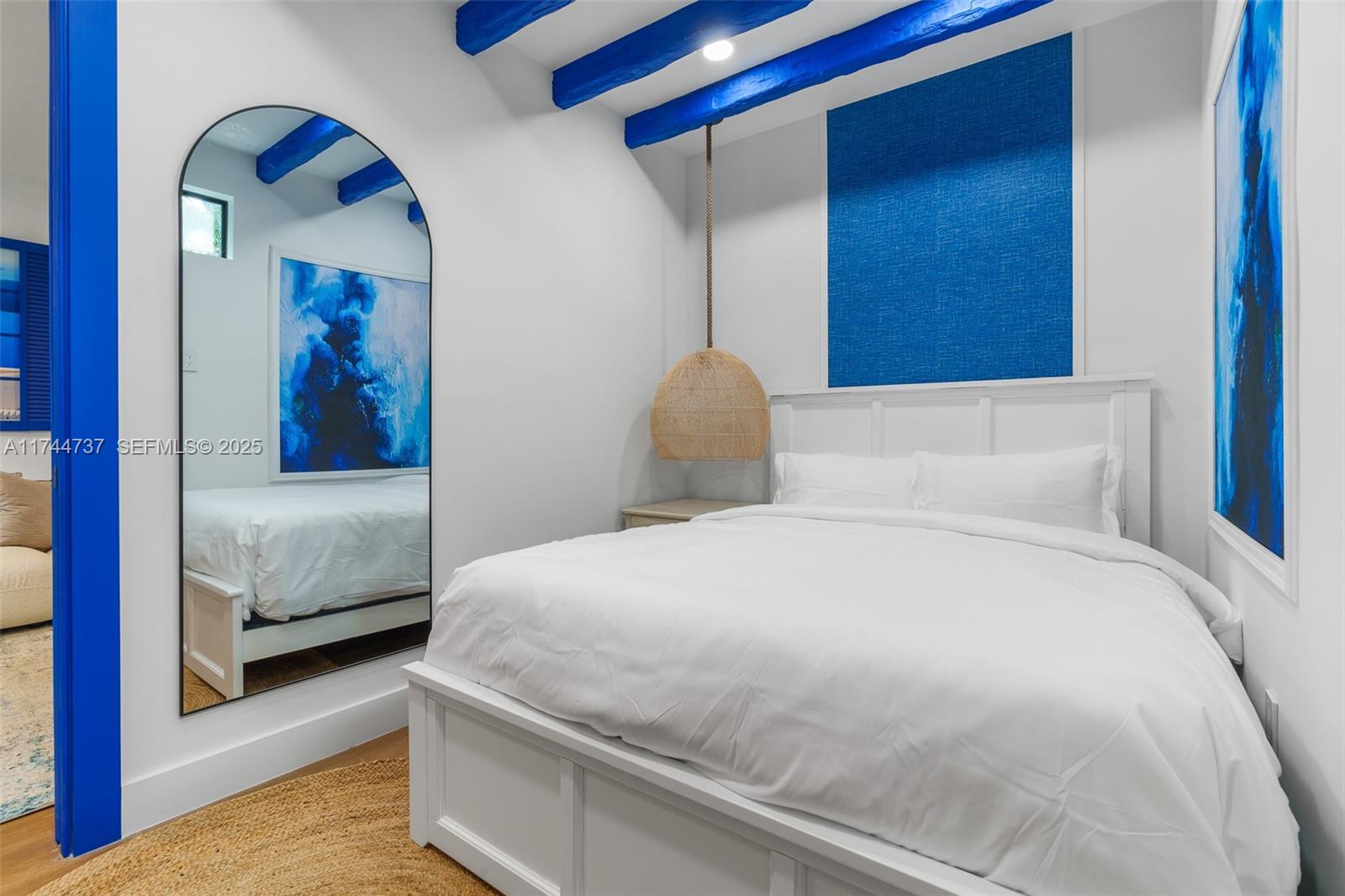 408 Northwest 52nd Street Miami, FL 33127 - Photo 16 of 73 a bedroom with a large bed and a painting on the wall