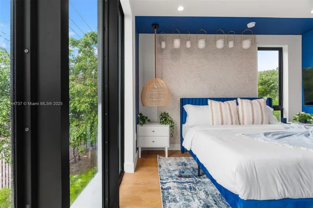 a bedroom with bed and wooden floor