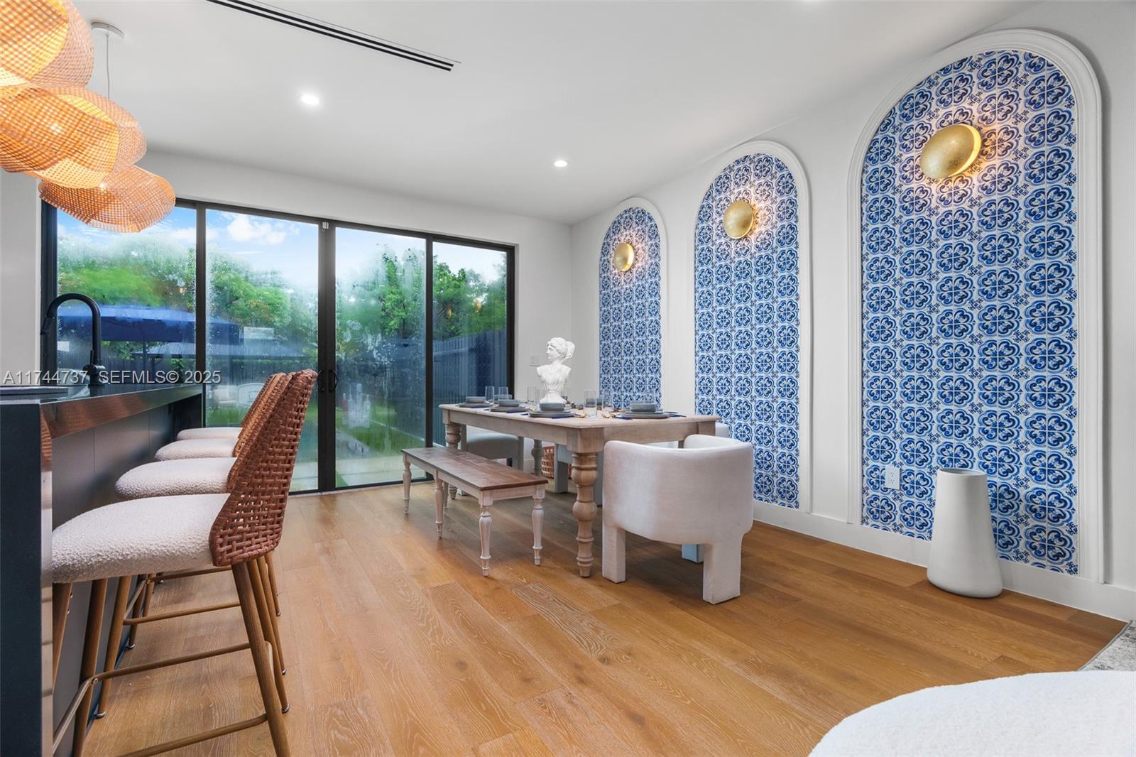408 Northwest 52nd Street Miami, FL 33127 - Photo 4 of 73 a dining room with furniture a chandelier and wooden floor