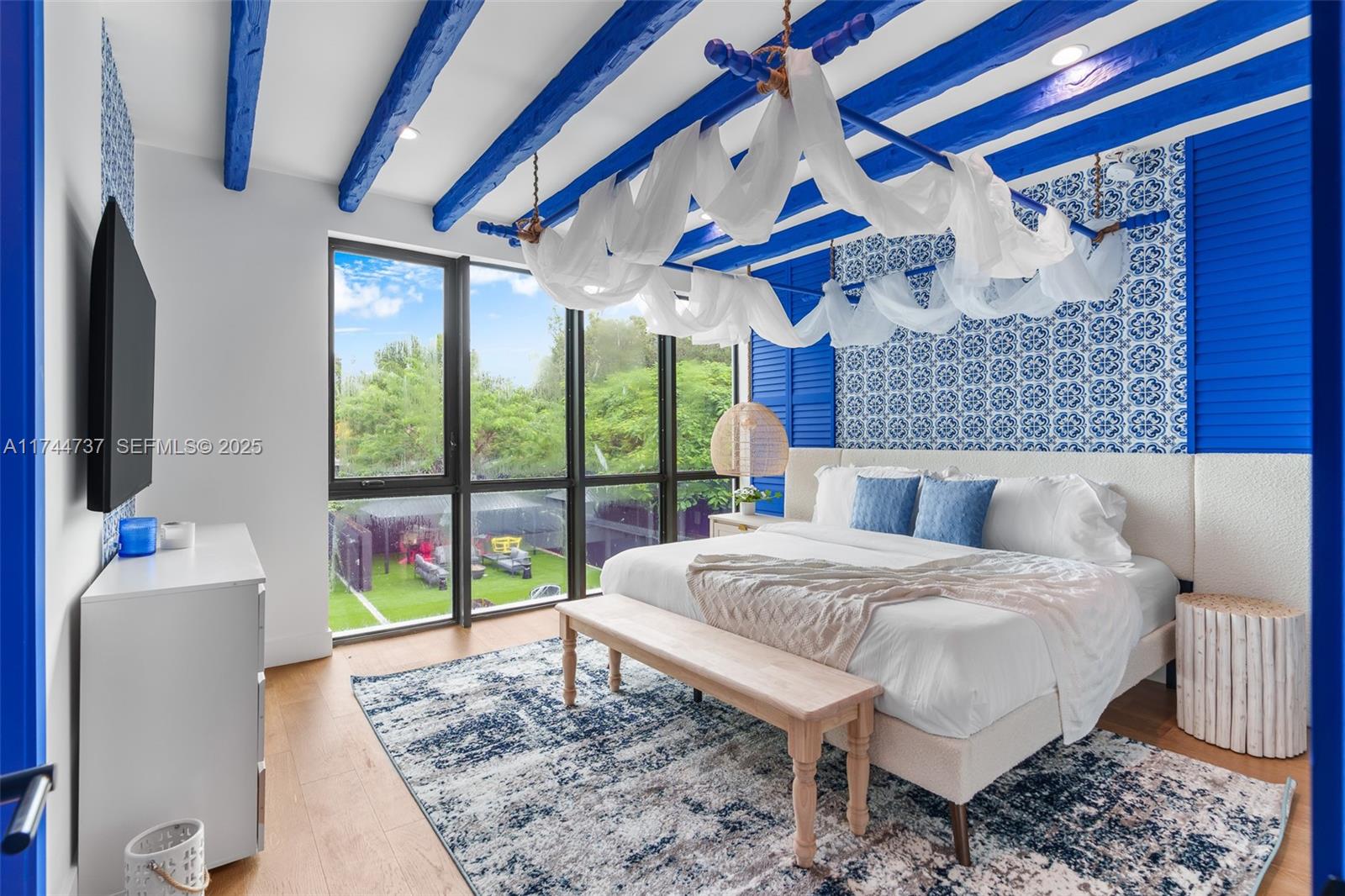 408 Northwest 52nd Street Miami, FL 33127 - Photo 41 of 73 a bedroom with a bed and a large window with outer view