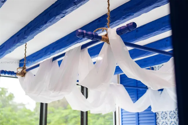 a view of a swimming pool and lounge chairs in the patio