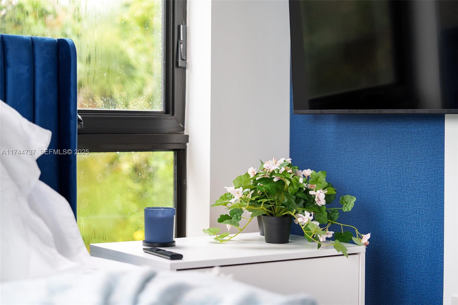 408 Northwest 52nd Street Miami, FL 33127 - Photo 59 of 73 a view of a vase with flowers in front of a door