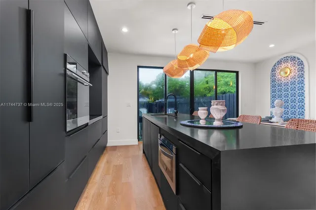 a view of a dining room with furniture and chandelier