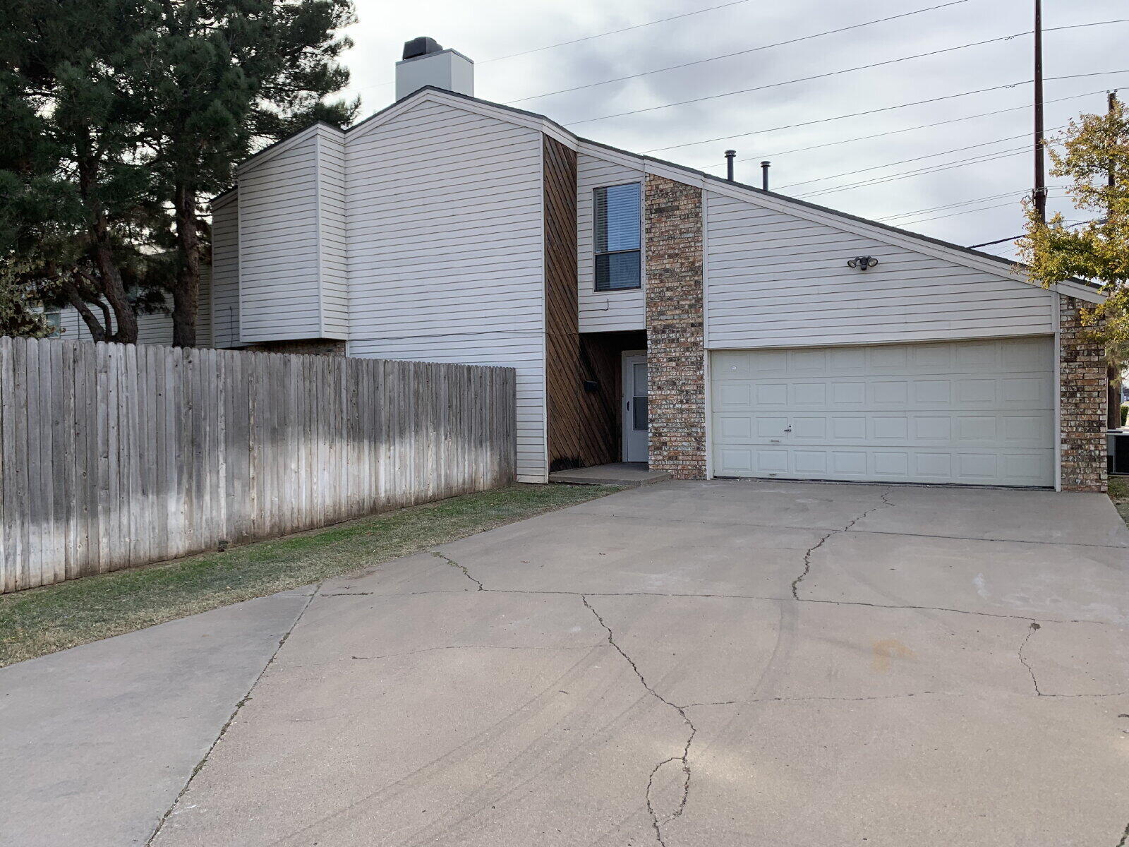 7201 Memphis Avenue, Unit B Lubbock, TX 79423 - Photo 1 of 14 a view of backyard of house with wooden fence