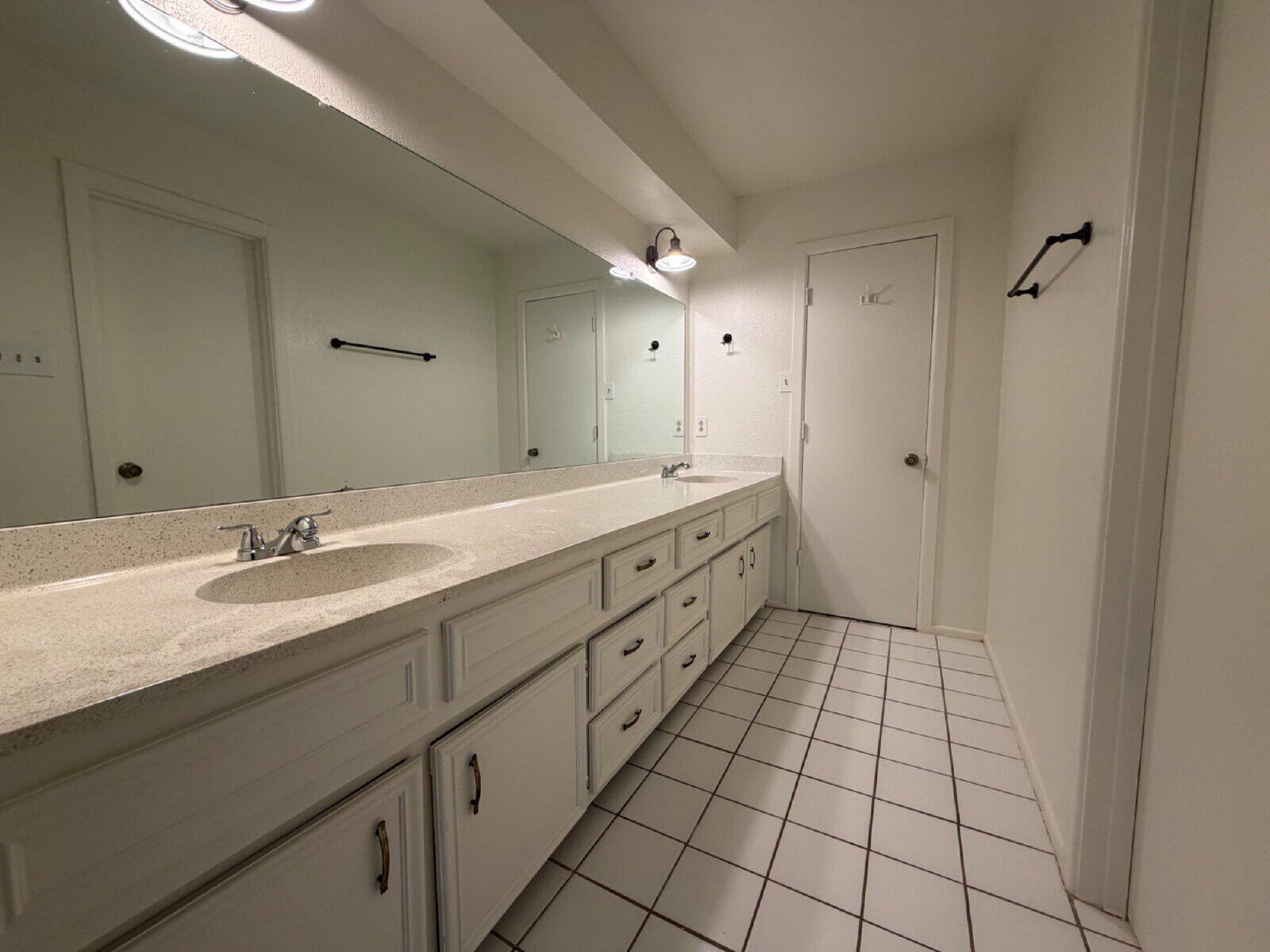 7201 Memphis Avenue, Unit B Lubbock, TX 79423 - Photo 11 of 14 a spacious bathroom with a double vanity sink a mirror and a