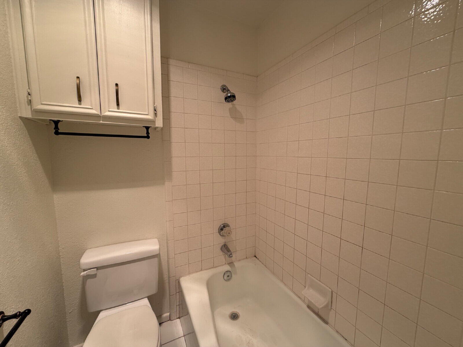 7201 Memphis Avenue, Unit B Lubbock, TX 79423 - Photo 12 of 14 a bathroom with a toilet a sink and mirror