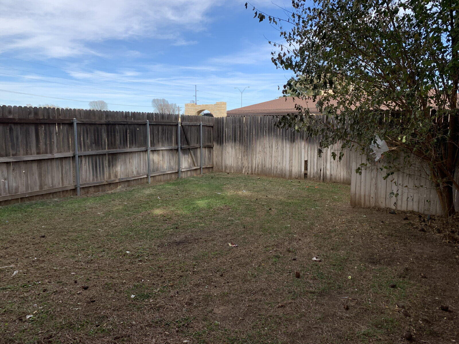 7201 Memphis Avenue, Unit B Lubbock, TX 79423 - Photo 14 of 14 a view of a backyard with wooden fence
