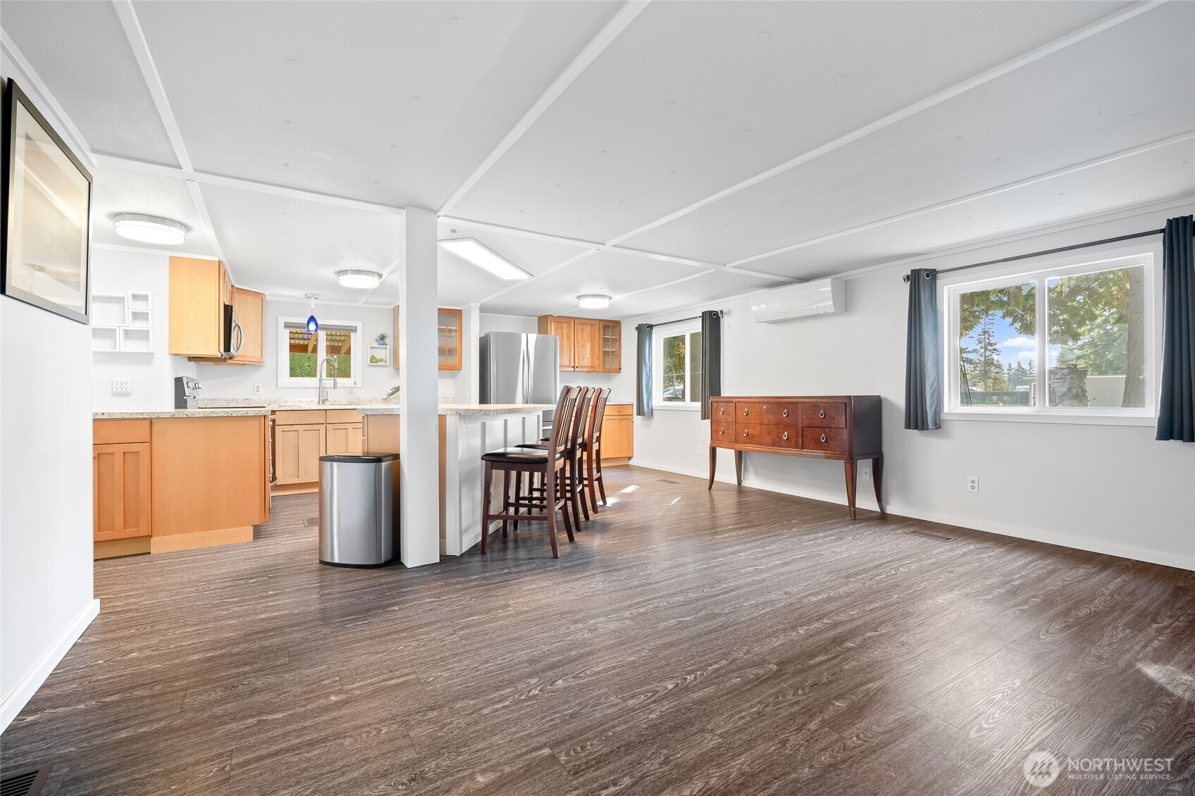 6978 Hannegan Road Lynden, WA 98264 - Photo 1 of 37 a living room with furniture and a dining table with wooden floor