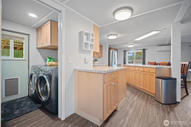 a kitchen with a sink a counter top space and stainless steel appliances