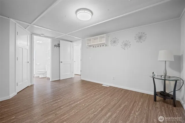 a view of a hallway with wooden floor