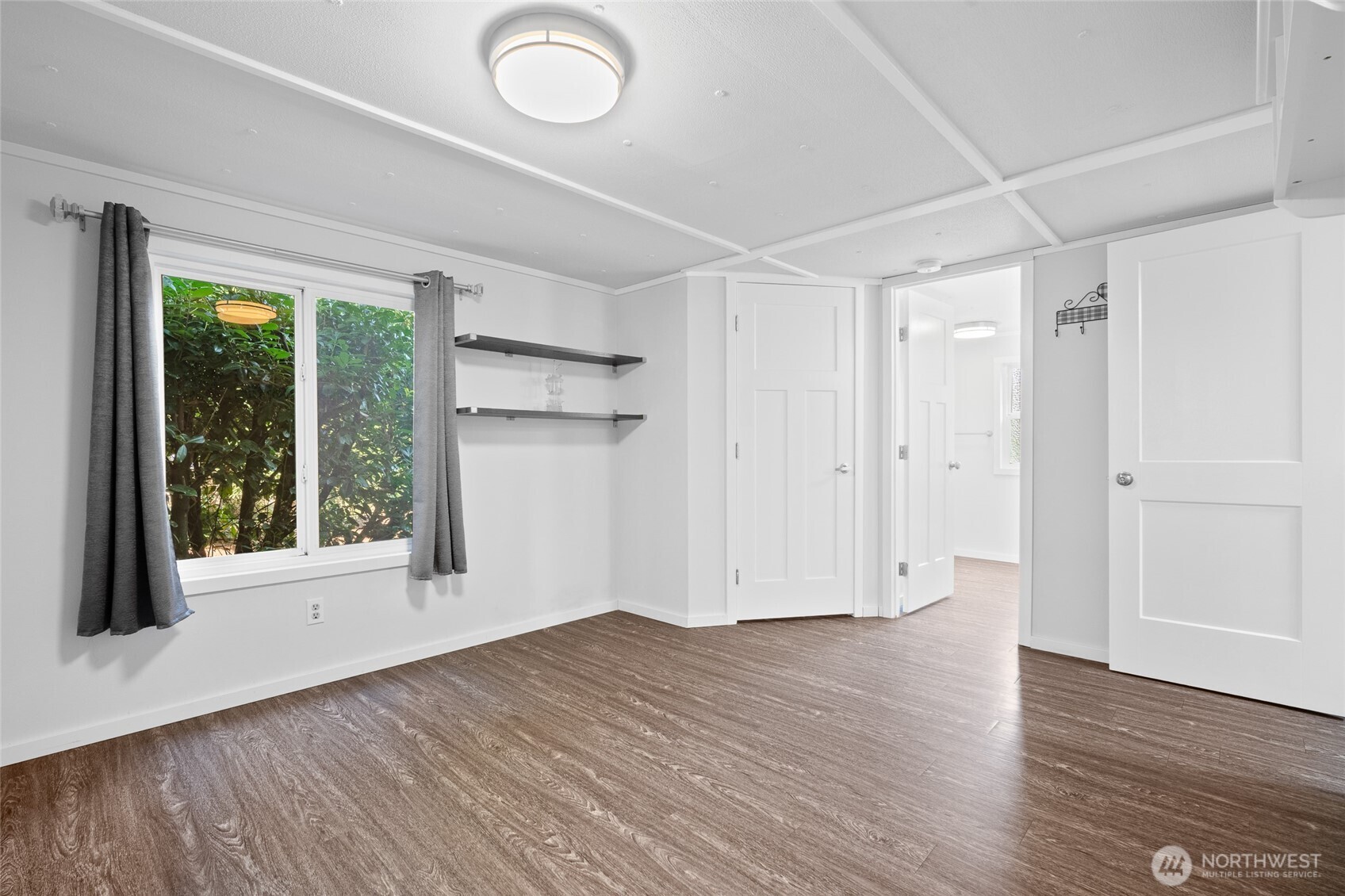 6978 Hannegan Road Lynden, WA 98264 - Photo 18 of 37 a view of empty room with wooden floor and fan