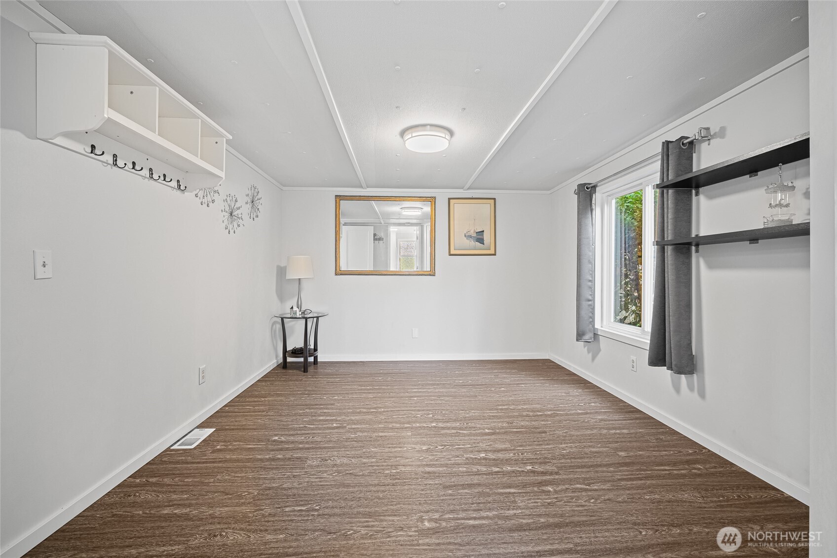 6978 Hannegan Road Lynden, WA 98264 - Photo 20 of 37 a view of an empty room with wooden floor and a window