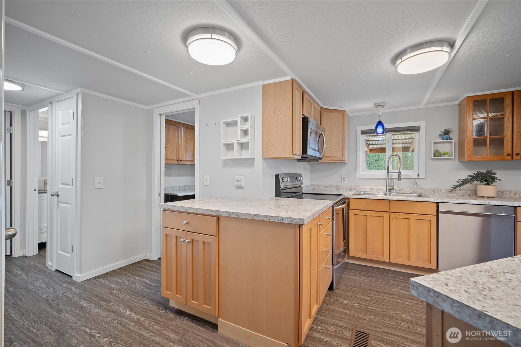 6978 Hannegan Road Lynden, WA 98264 - Photo 21 of 37 a kitchen with stainless steel appliances granite countertop a sink stove and refrigerator