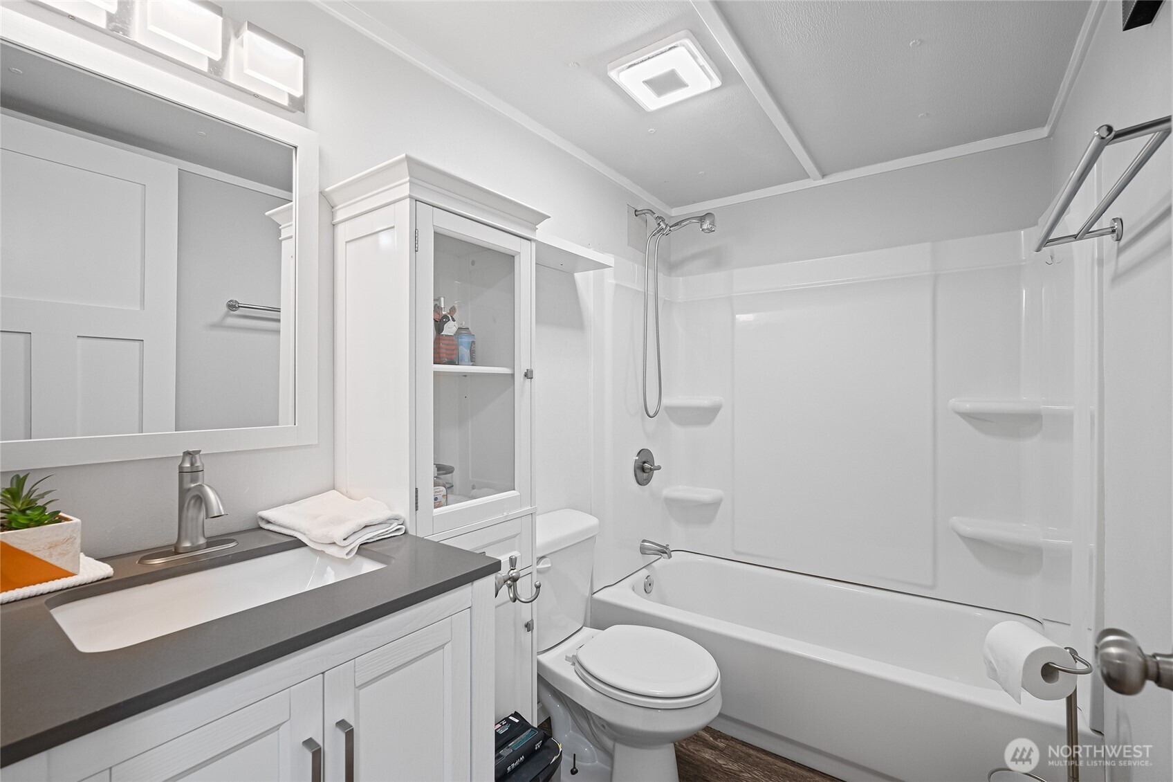 6978 Hannegan Road Lynden, WA 98264 - Photo 23 of 37 a bathroom with a granite countertop sink a toilet and shower