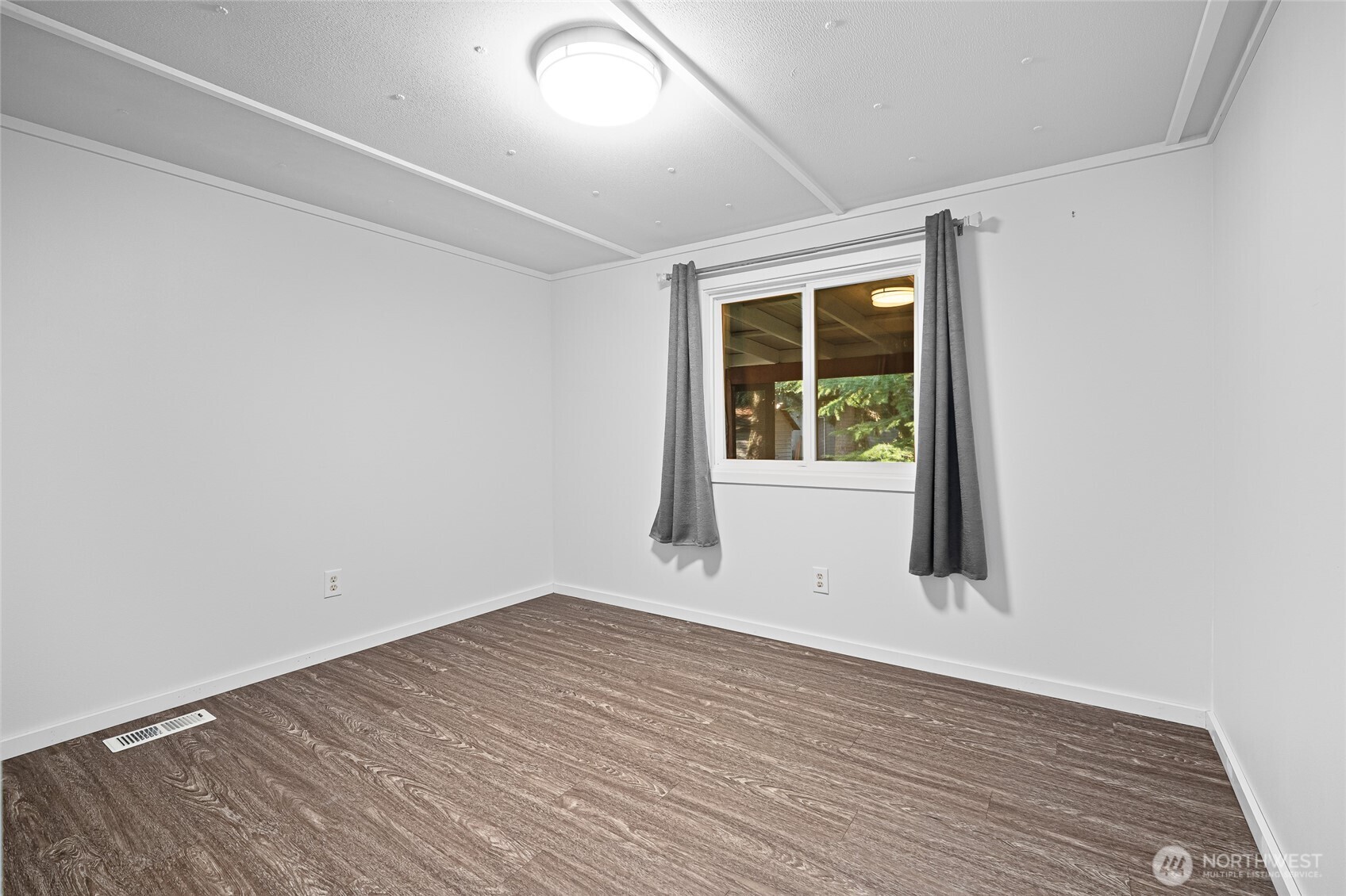 6978 Hannegan Road Lynden, WA 98264 - Photo 25 of 37 an empty room with wooden floor and windows