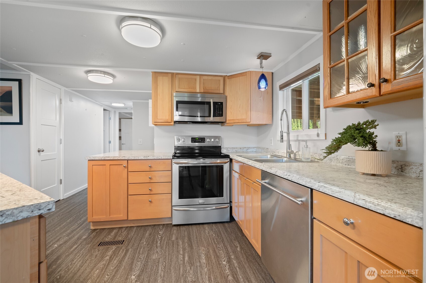 6978 Hannegan Road Lynden, WA 98264 - Photo 10 of 37 a kitchen with stainless steel appliances granite countertop a stove a sink and a refrigerator