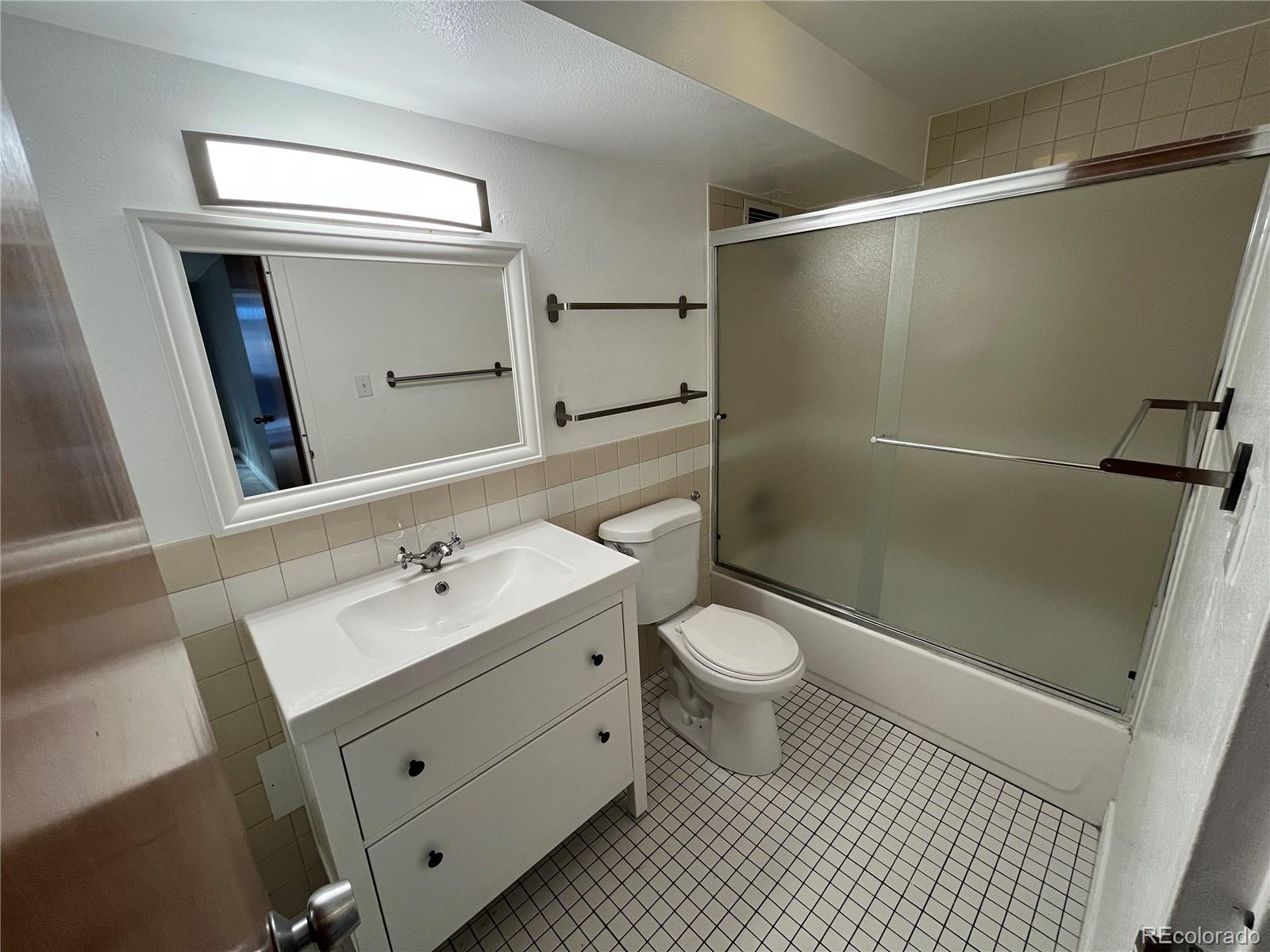 1155 Ash Street, Unit 202 Denver, CO 80220 - Photo 15 of 21 a bathroom with a sink a toilet and shower