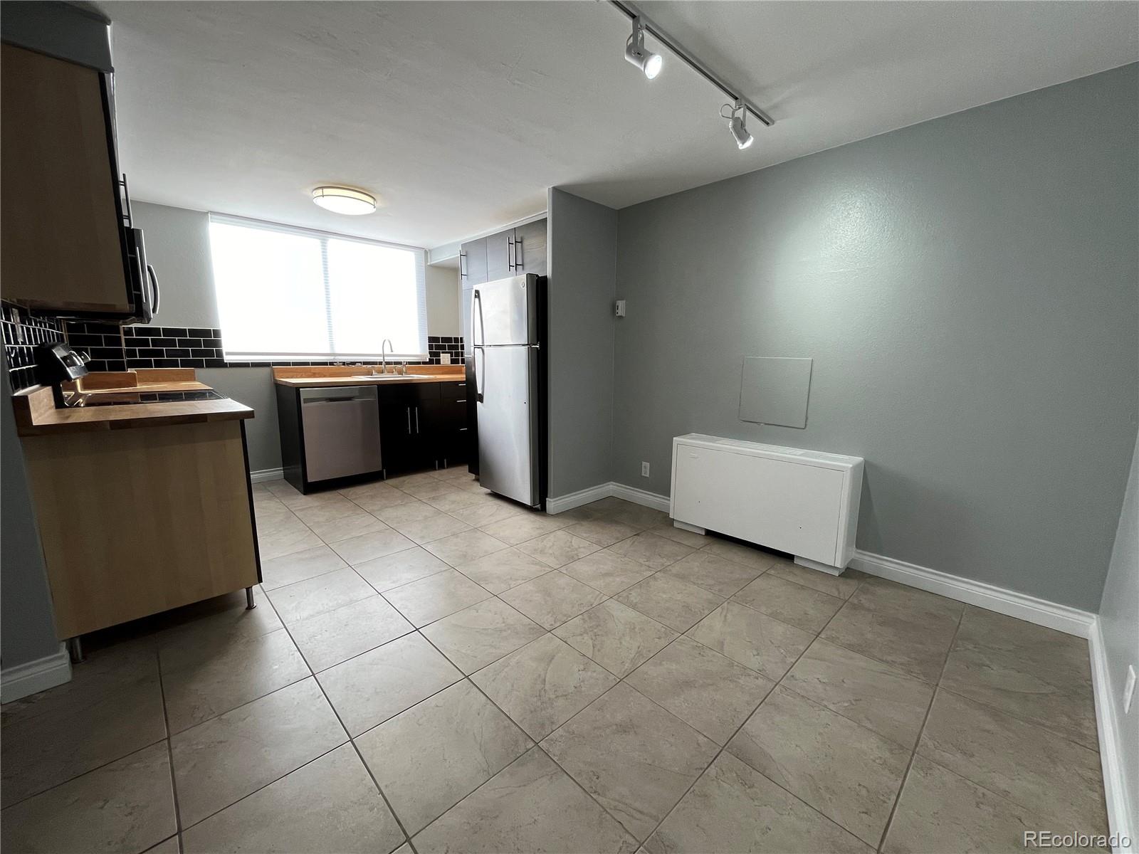 1155 Ash Street, Unit 202 Denver, CO 80220 - Photo 19 of 21 a kitchen with a sink a counter top space and appliances