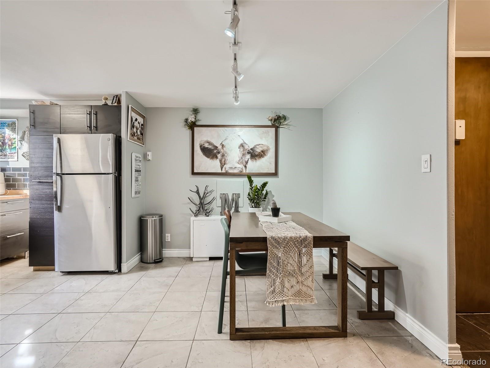 1155 Ash Street, Unit 202 Denver, CO 80220 - Photo 4 of 21 a view of a kitchen with refrigerator and furniture