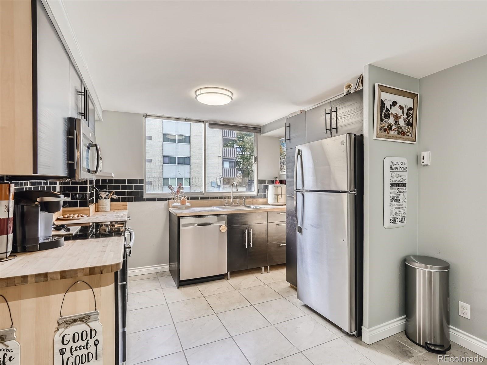 1155 Ash Street, Unit 202 Denver, CO 80220 - Photo 5 of 21 a kitchen with a refrigerator sink and stove