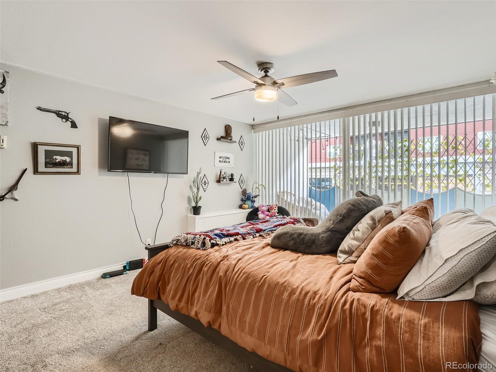 1155 Ash Street, Unit 202 Denver, CO 80220 - Photo 7 of 21 a bedroom with a bed and a flat screen tv