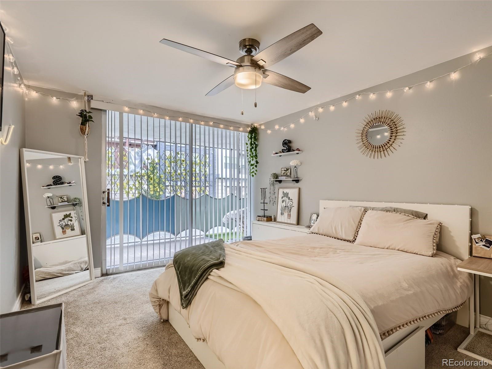 1155 Ash Street, Unit 202 Denver, CO 80220 - Photo 9 of 21 a bedroom with a large bed and a chandelier