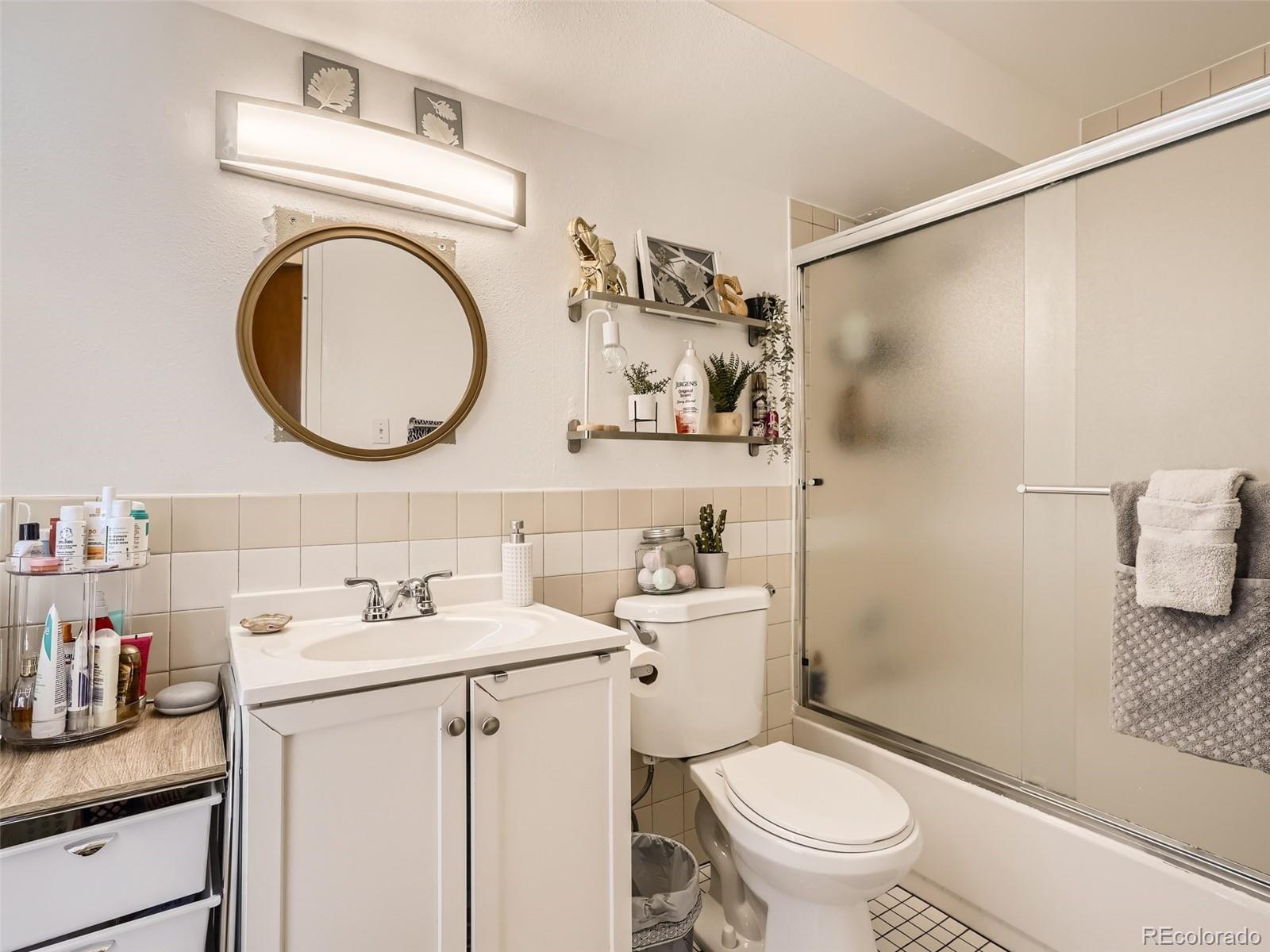 1155 Ash Street, Unit 202 Denver, CO 80220 - Photo 10 of 21 a bathroom with a granite countertop sink mirror vanity and toilet