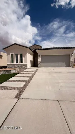 a view of house with yard and large tree in front of it