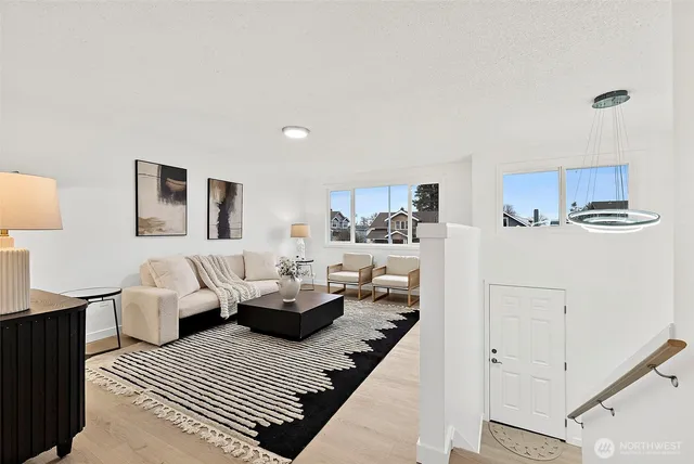 a bedroom with a bed a couch and window