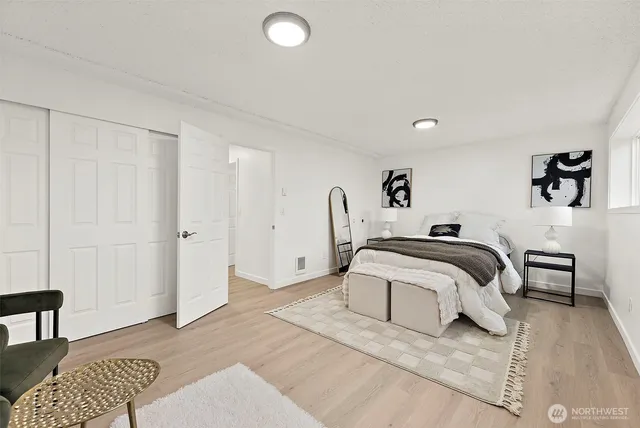 a bedroom with a bed and a chair