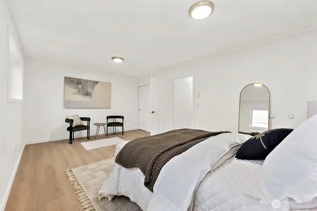 a bedroom with a bed and a chair