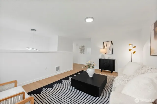 a living room with furniture a couch and a flat screen tv