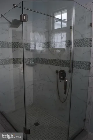 a bathroom with a toilet and a mirror